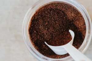 Best Ground Coffee, photo of ground coffee with a white scoop.