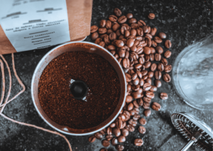 best coffee grinder for french press, photo of ground coffee with coffee beans next to it
