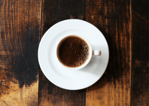 how to make an americano, photo of a white coffee mug with coffee on a wooden surface