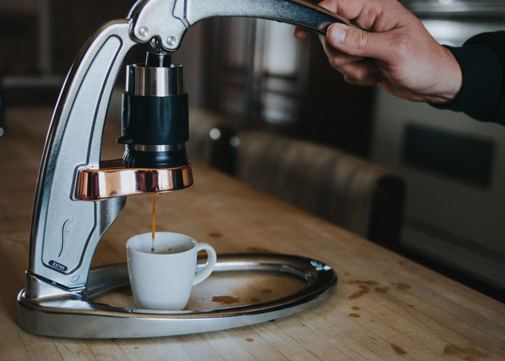 Photo of gray flair espresso maker being used to make a cup of espresso