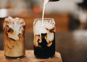 iced flat coffee, coffee cream being poured into iced flat white